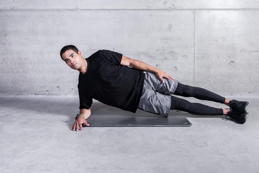 man doing side plank with arm down