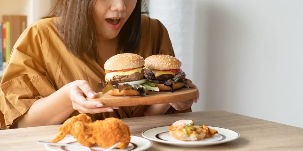 woman holding hamburger platter