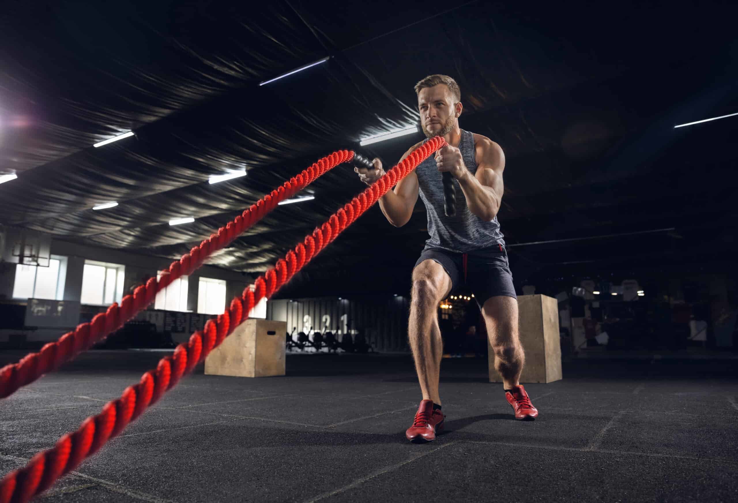 man exercising with ropes