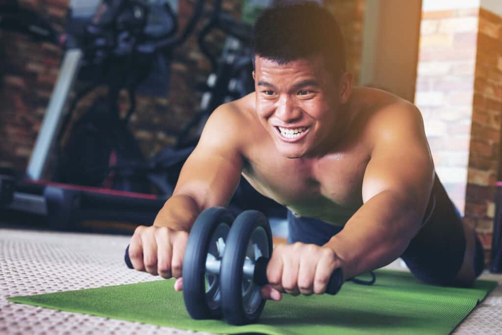 man doing ab rollout