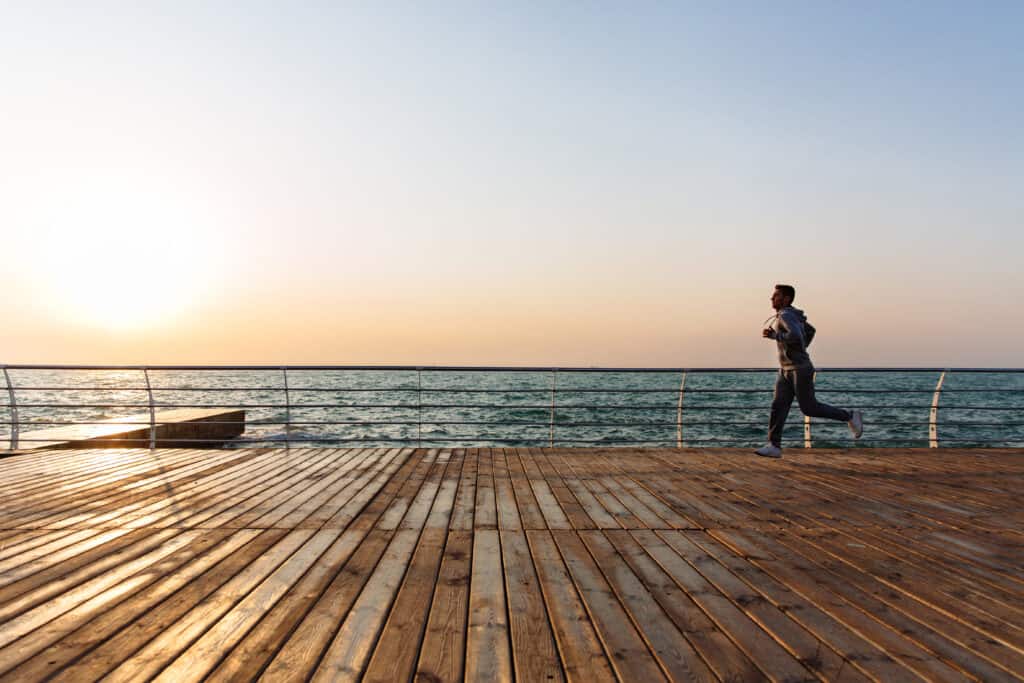 man jogging on pier