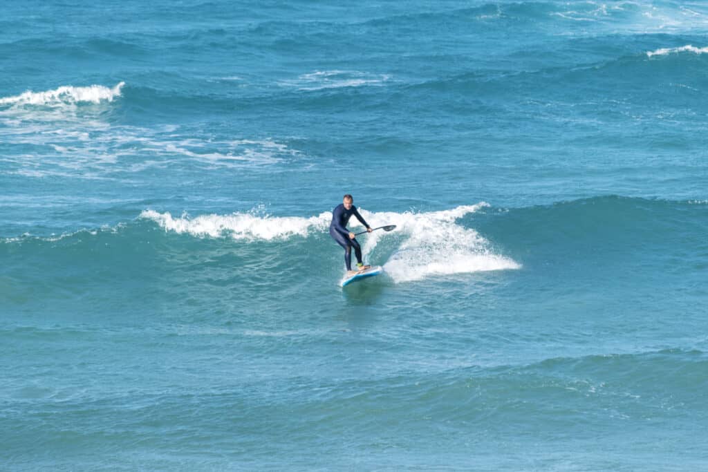 man paddle surfing