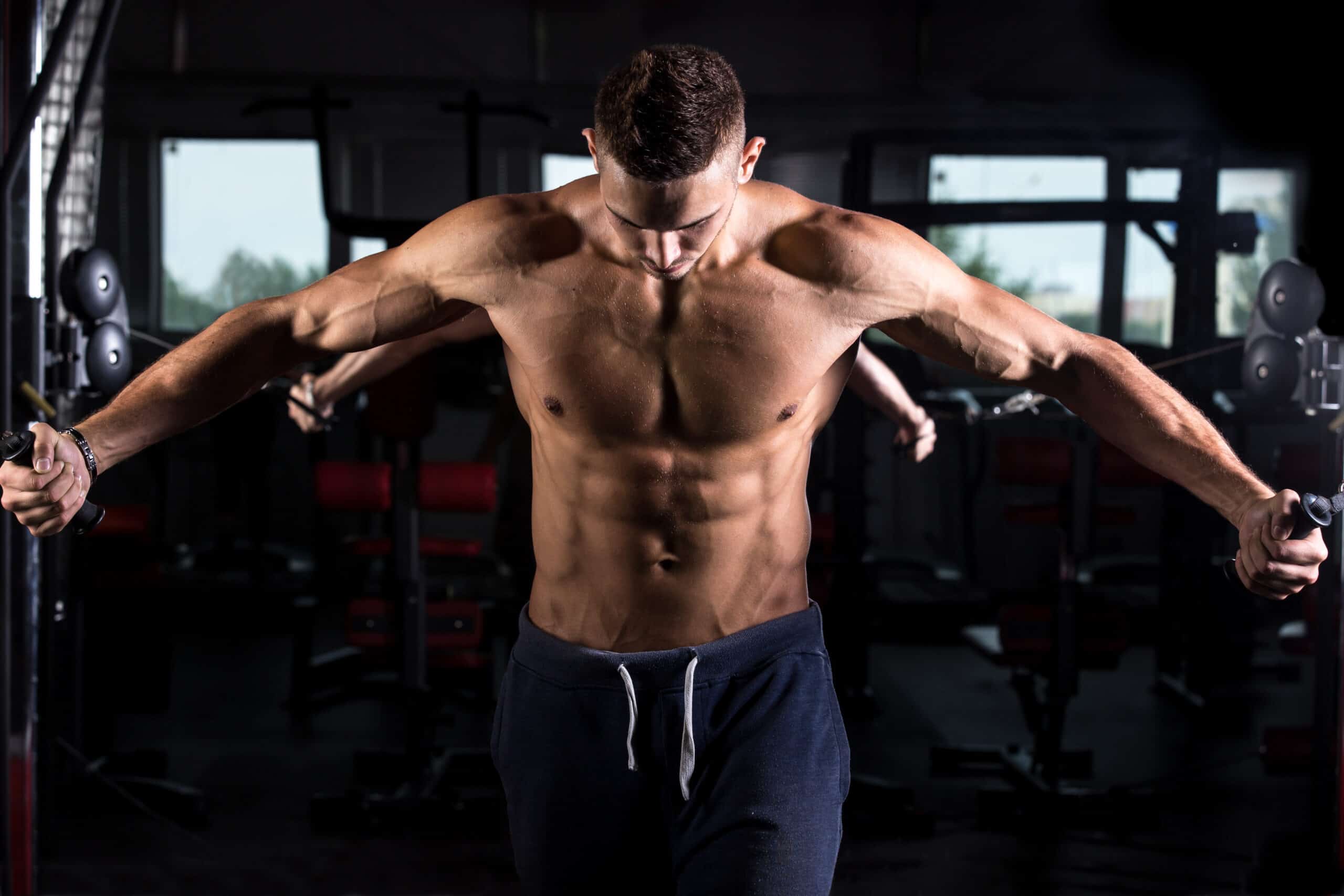 man training on crossover machine