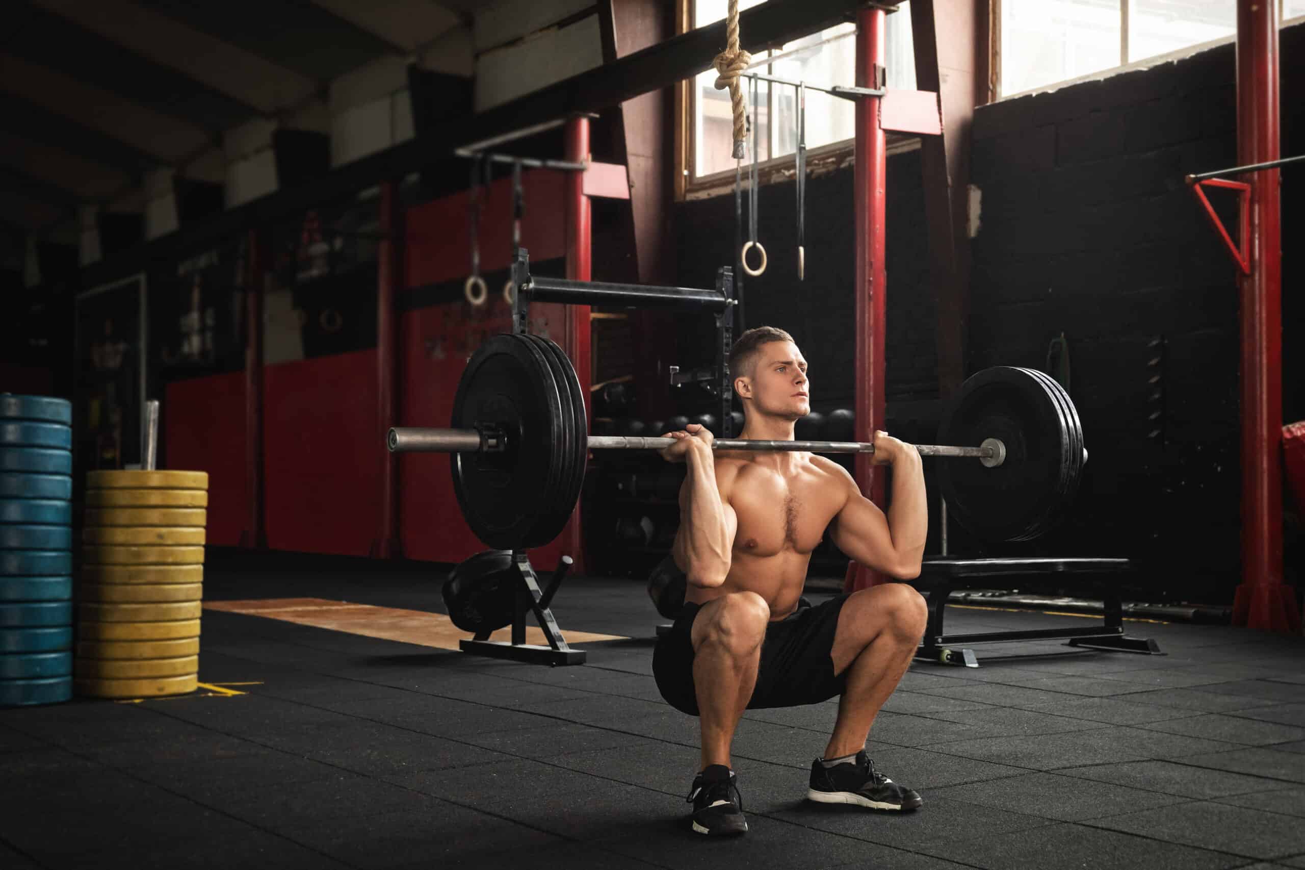 man performing deep squat