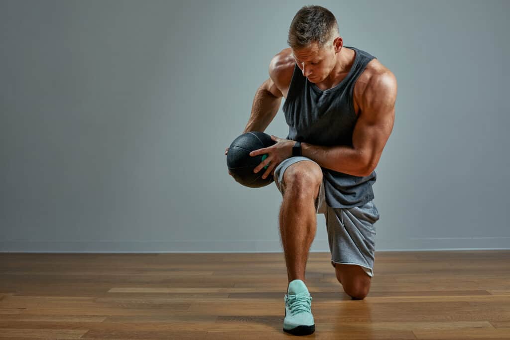 man exercising with medicine ball