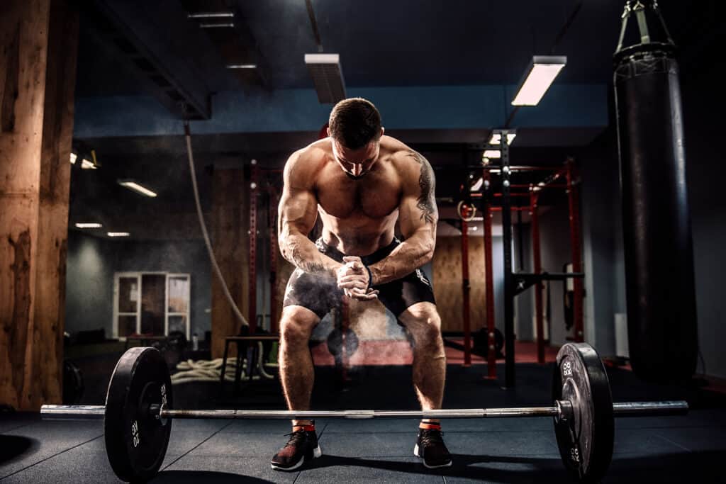 man preparing to deadlift barbell