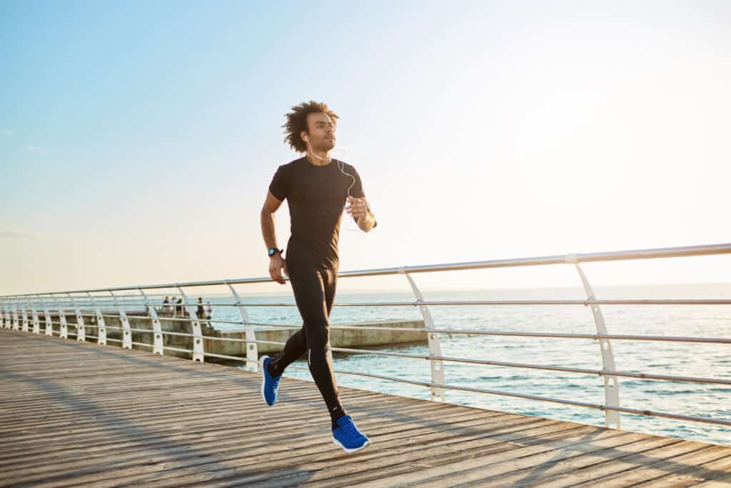 man jogging on pier