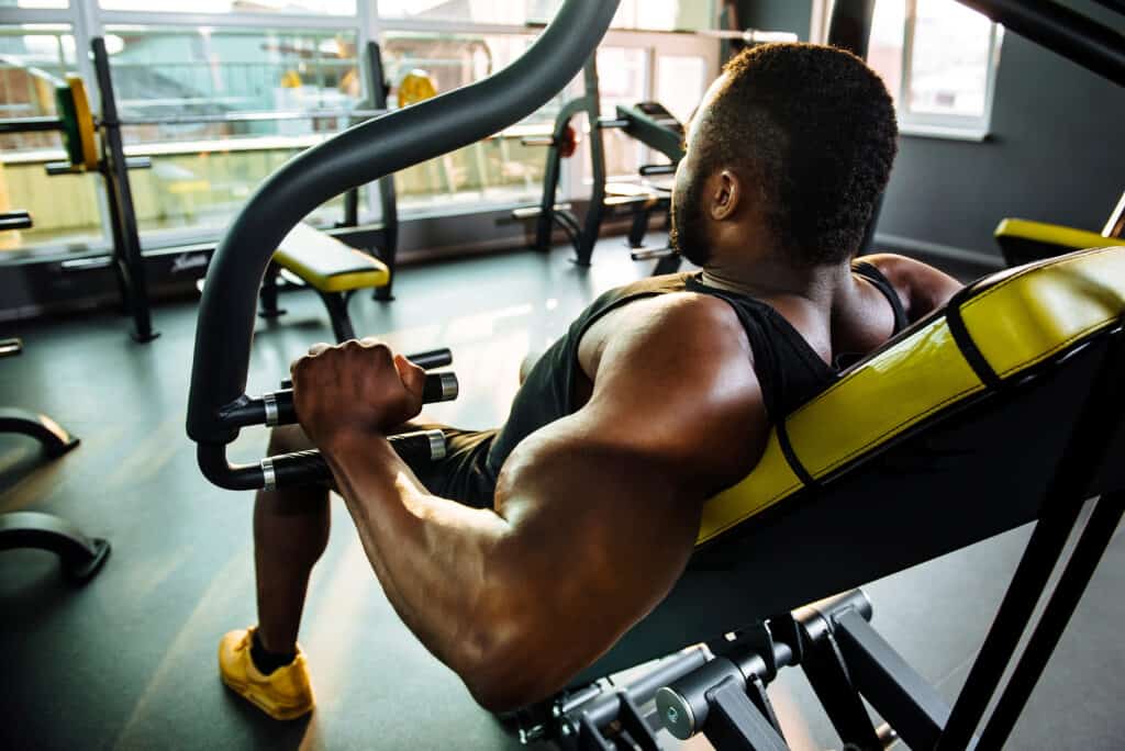 man working out at gym on machine