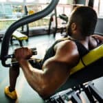 man working out at gym on machine