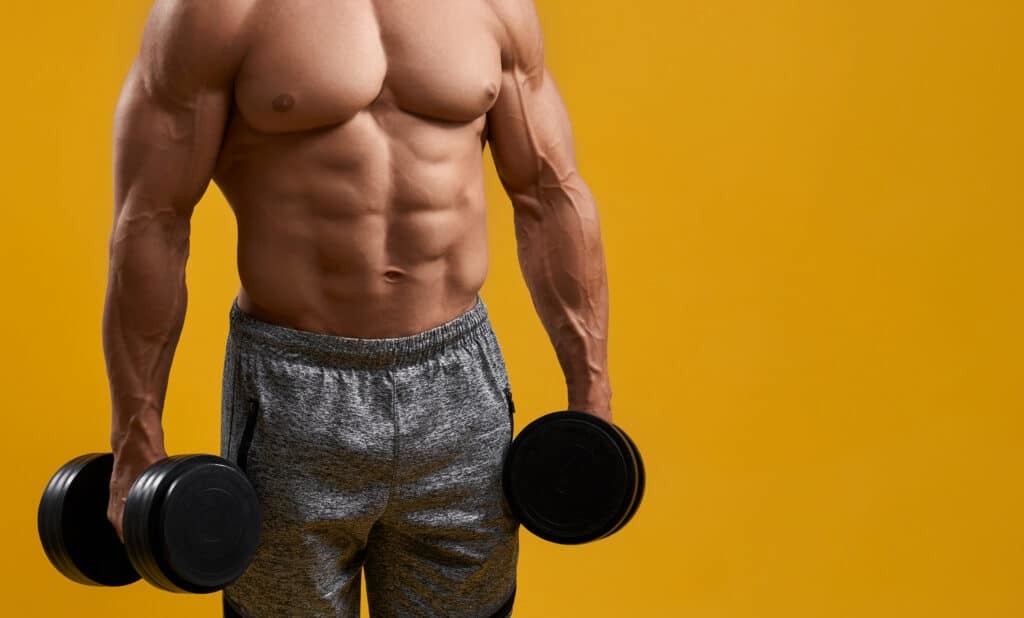 muscular man holding dumbbells