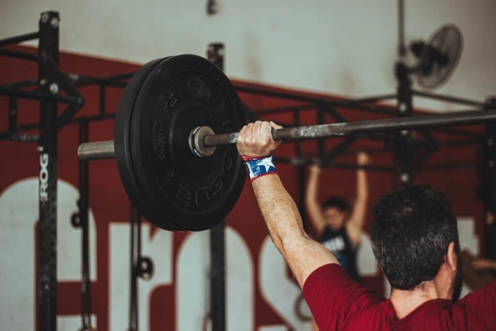 man holding barbell over his head