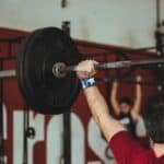 man holding barbell over his head