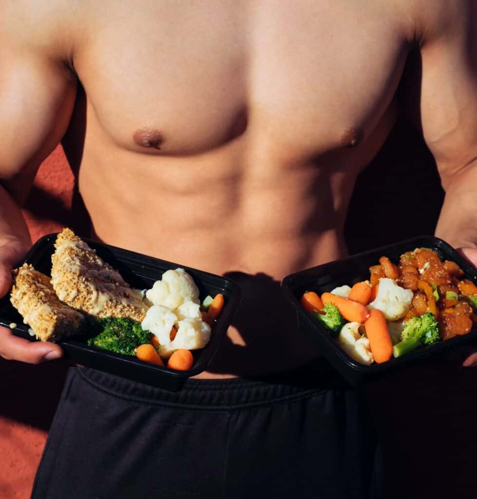 man holding plates of healthy food