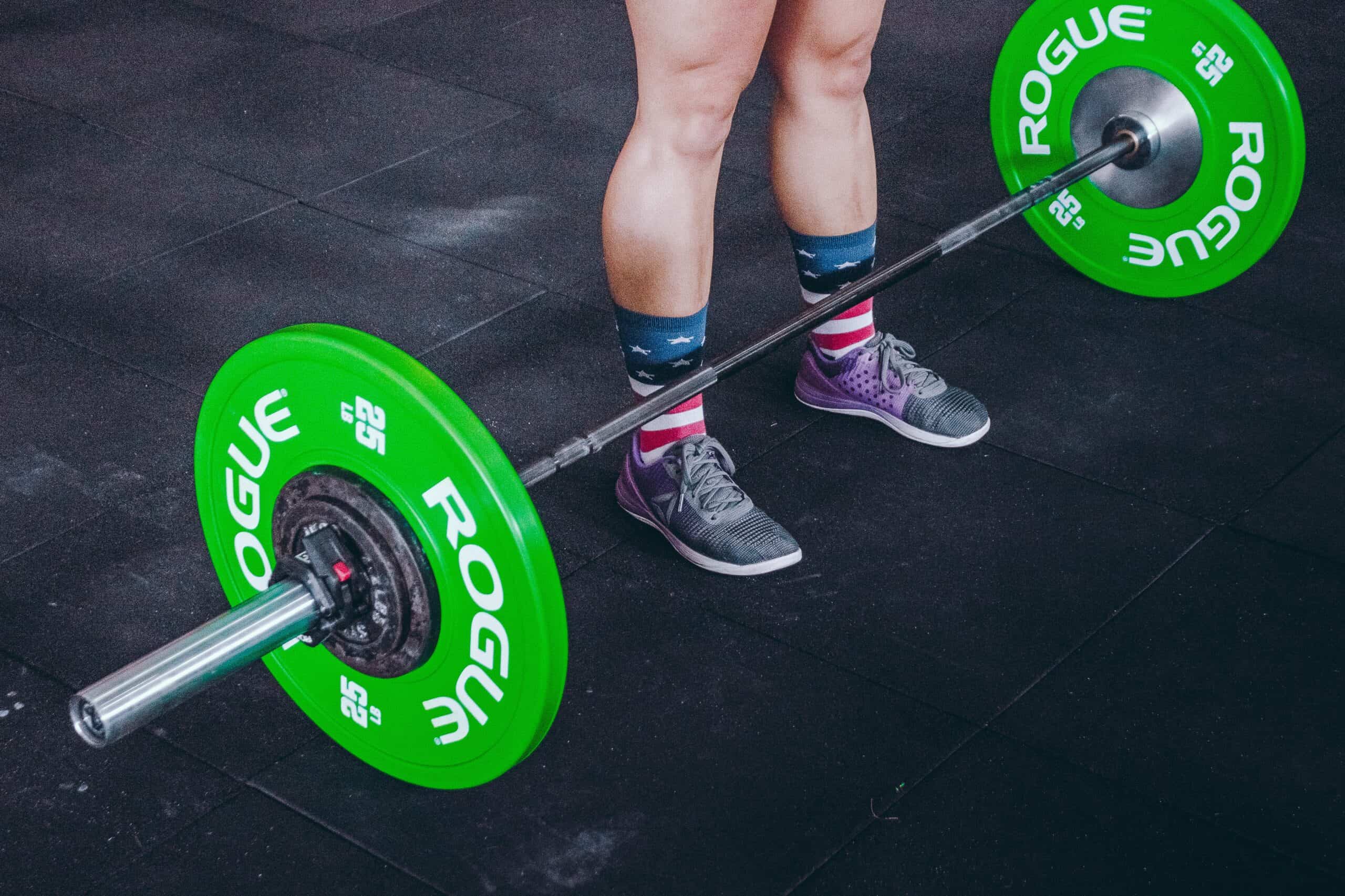 preparing to lift a barbell at the gym