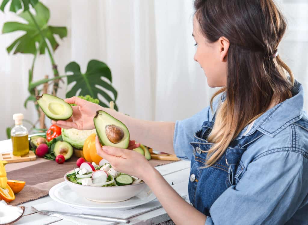 woman looking at avocados