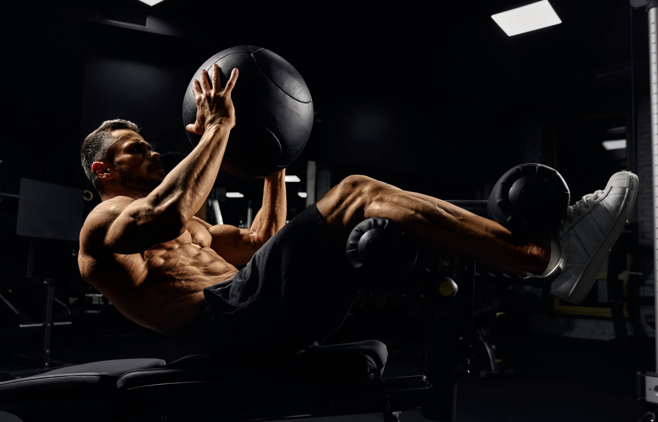man doing core exercises with medicine ball