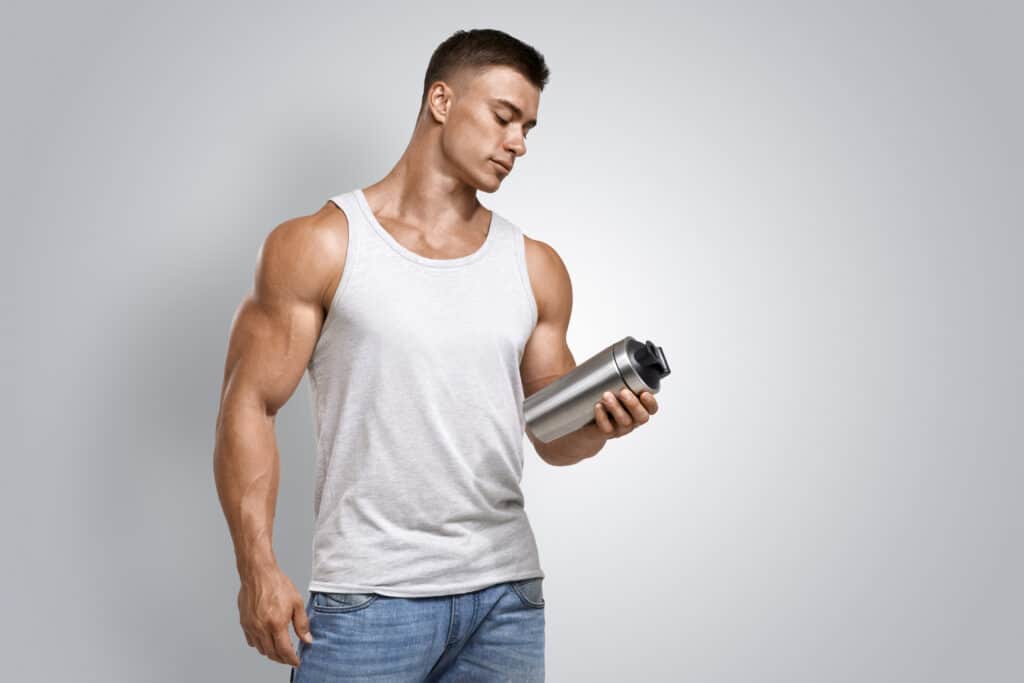 man holding protein shake