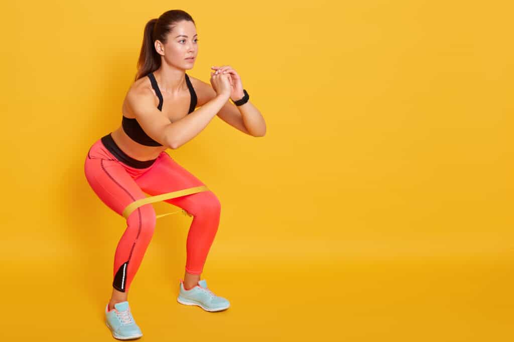 woman doing lunge with exercise band