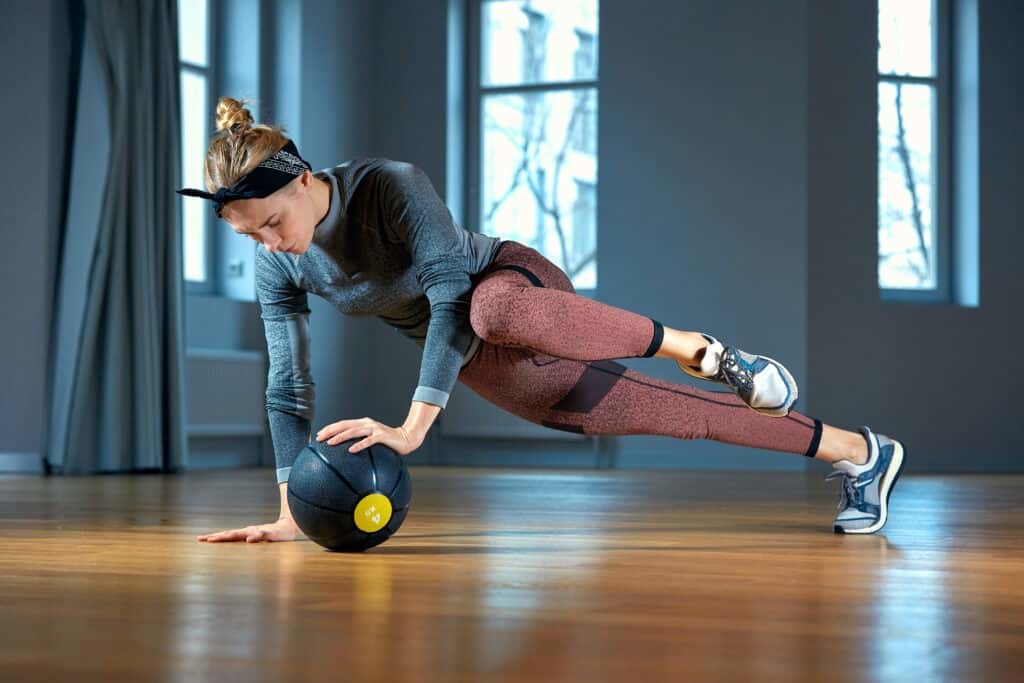 woman working out with medicine ball