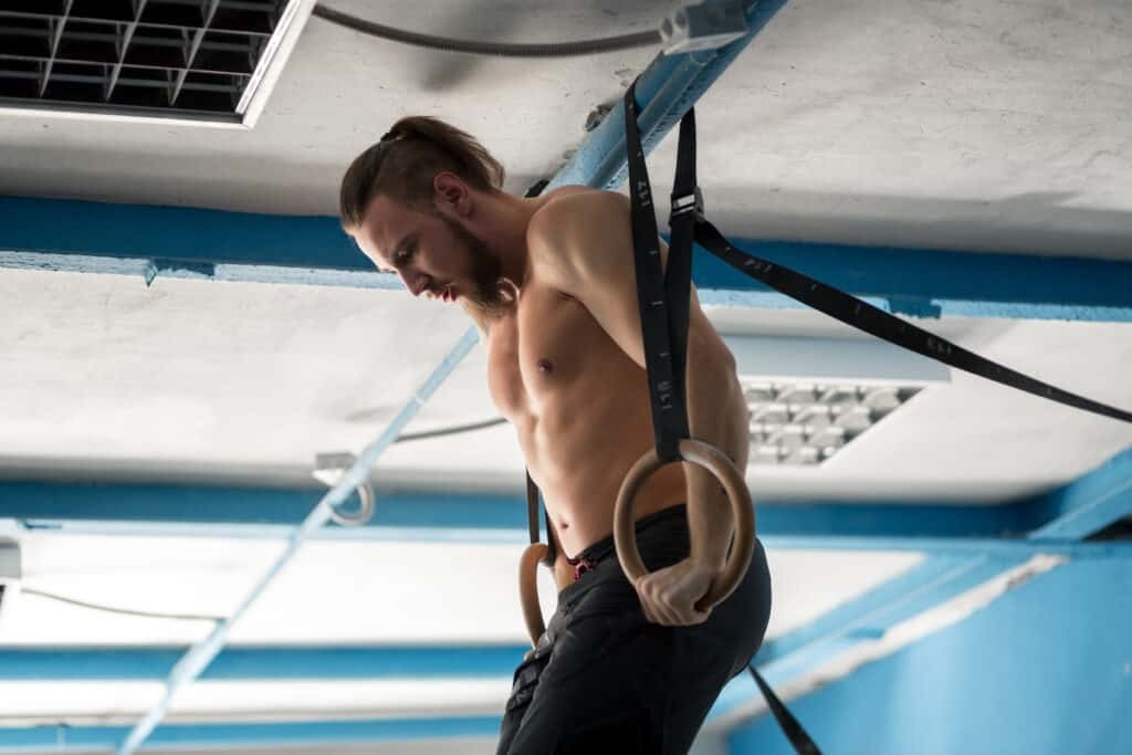 man exercising with exercise rings