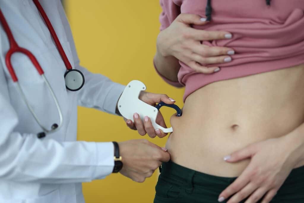 doctor using calipers to get body measurements