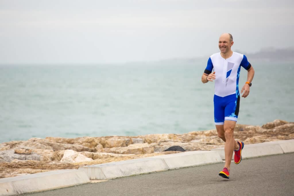 man running along the coast