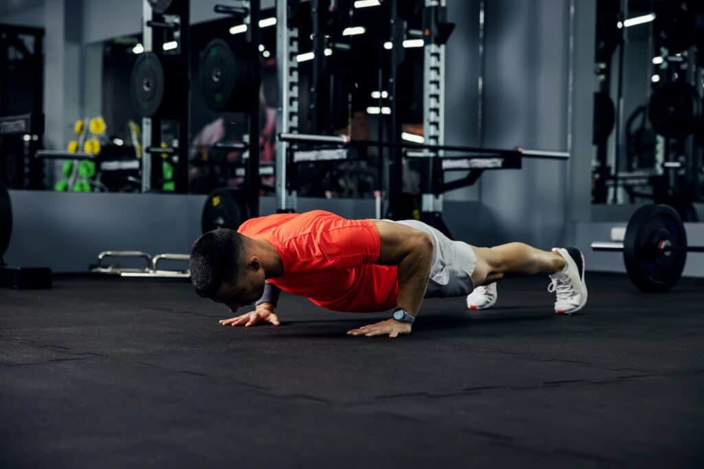 man doing pushup at the gym