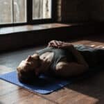 man lying on yoga mat