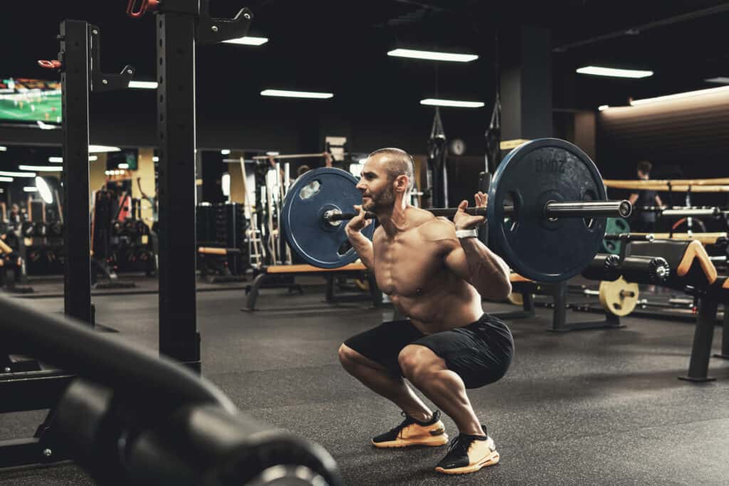 man doing barbell squat