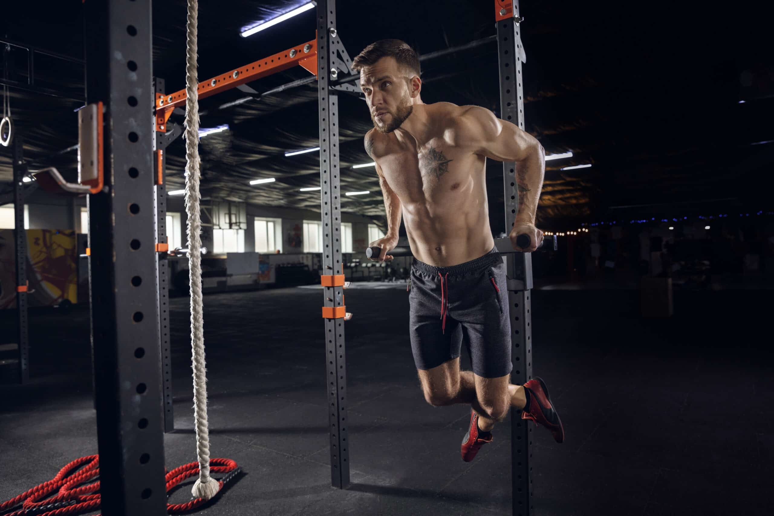 man doing pull ups at the gym