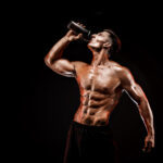 muscular man drinking protein shake