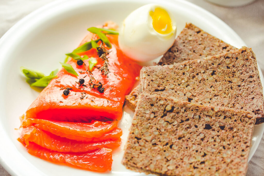 plate of healthy raw salmon and poached egg