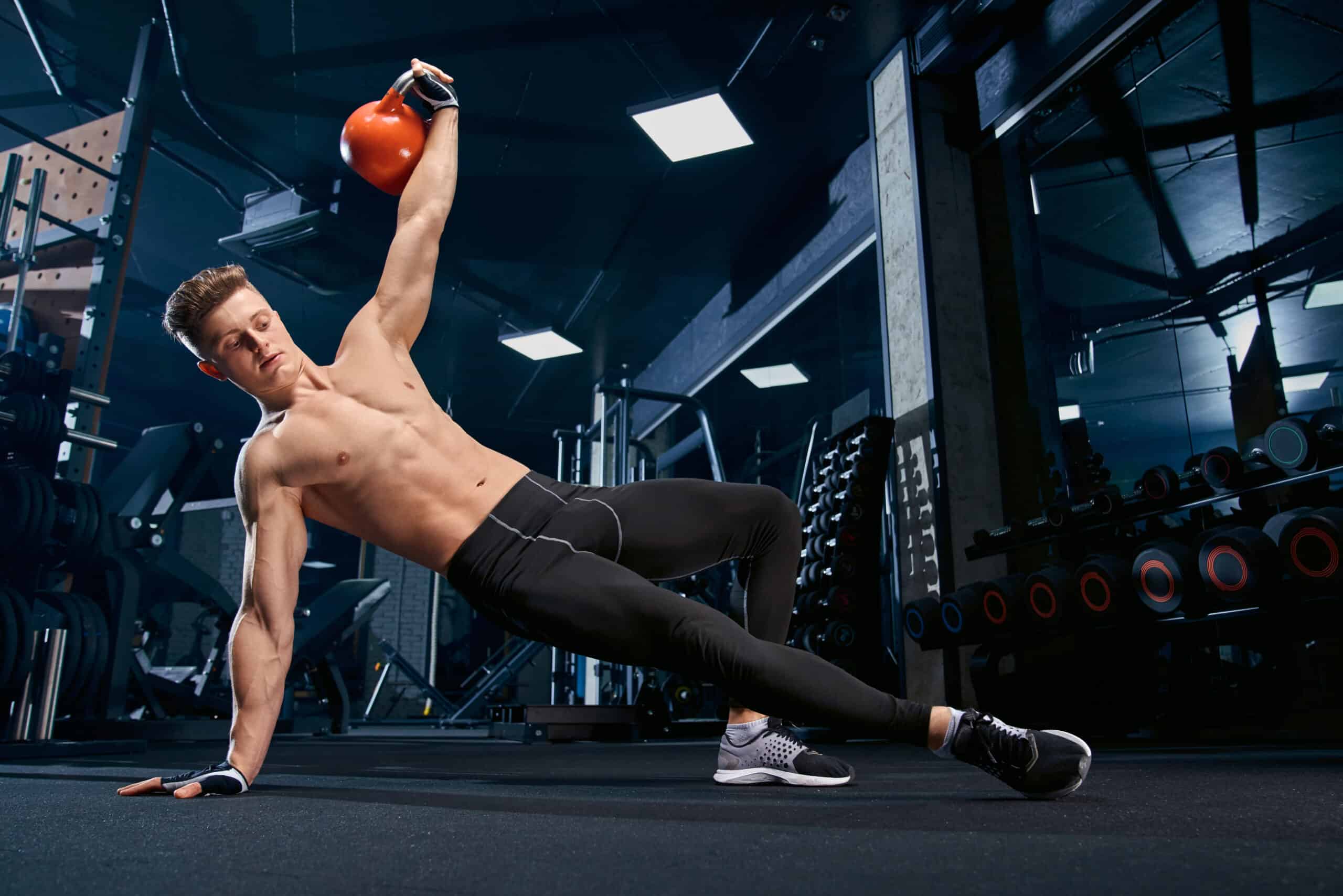man doing side plank with kettlebell