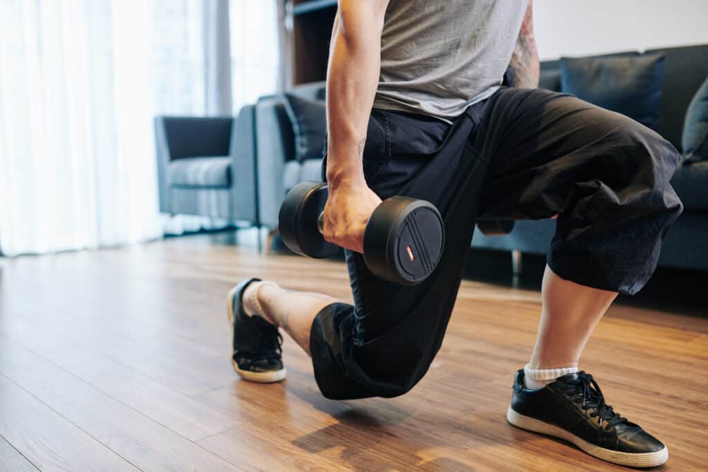 man doing dumbbell lunge