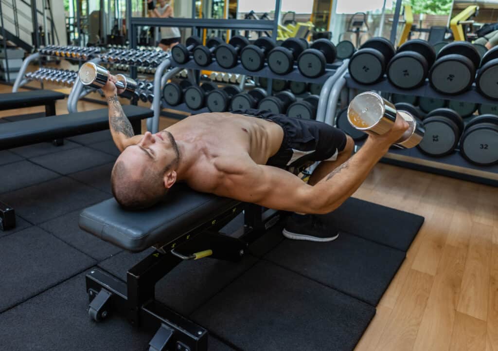 man performing dumbbell fly