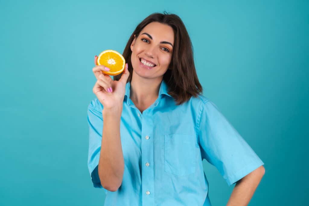 woman holding orange