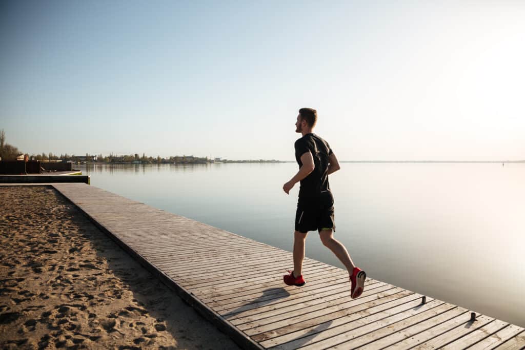 man jogging on a dock