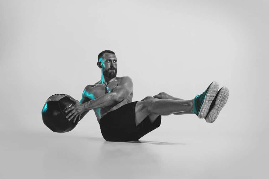 man doing ab workout with medicine ball