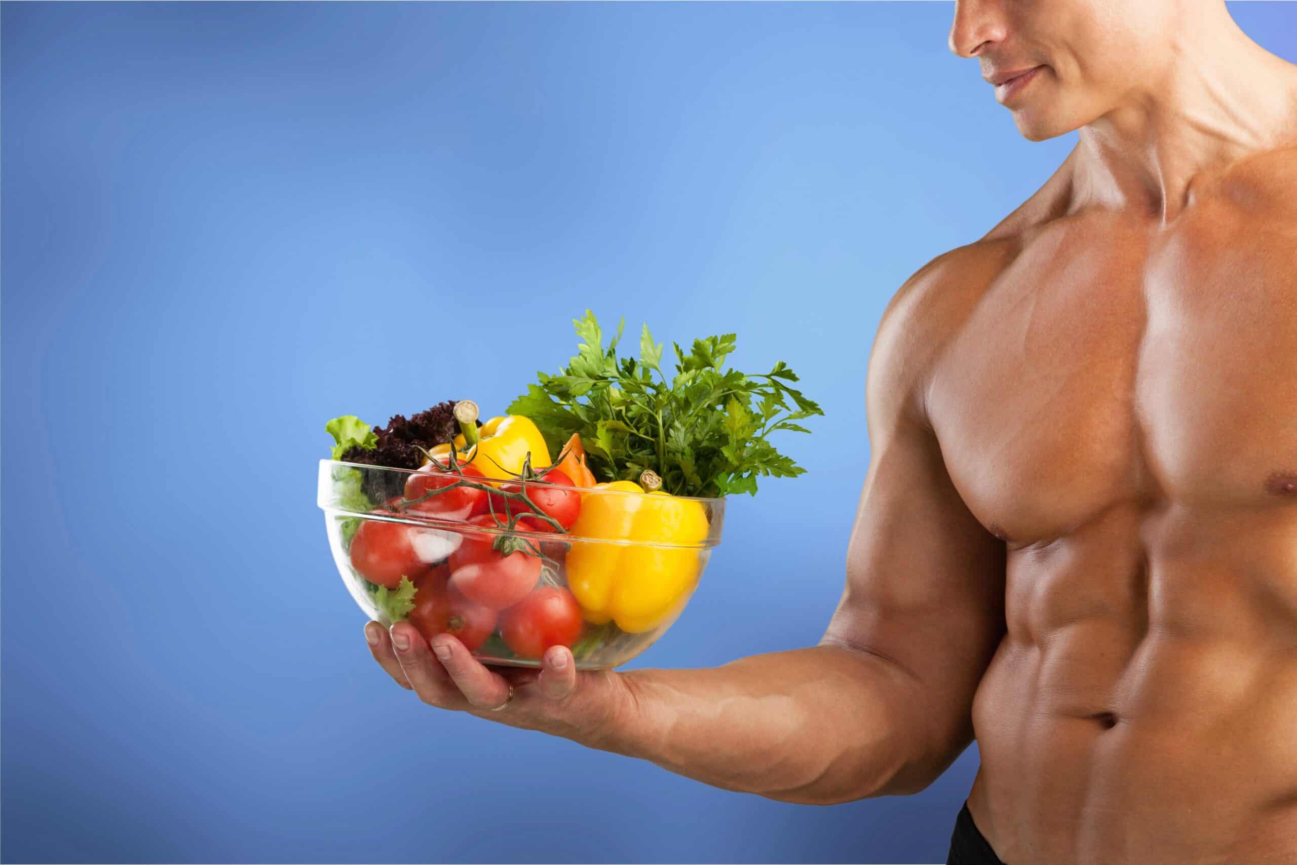 man holding bowl of healthy fruit