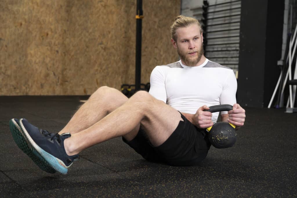 man doing kettlebell ab workout