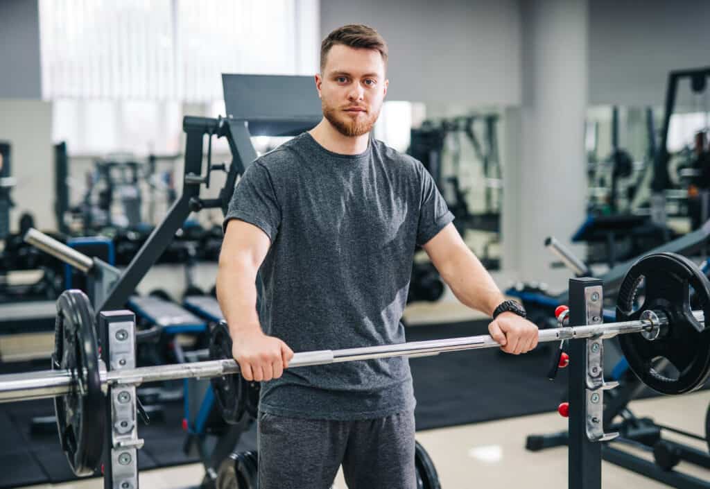 man standing over barbell bench press