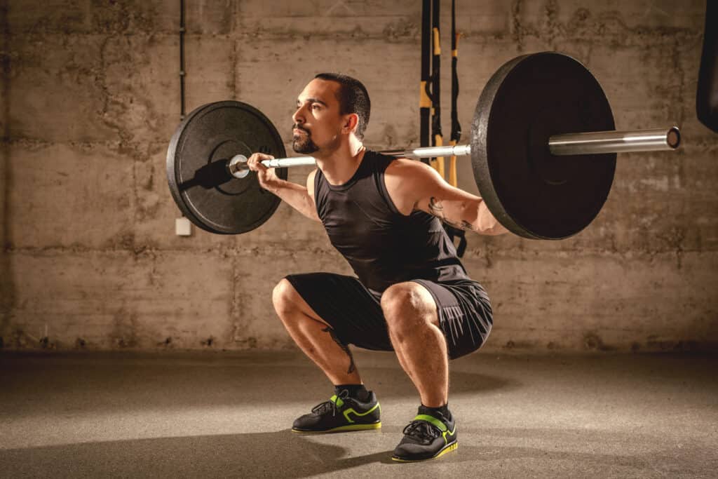 man doing barbell squat