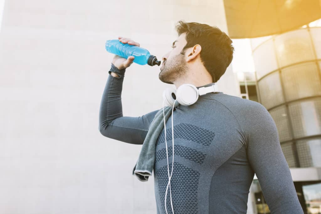 man drinking sports drink