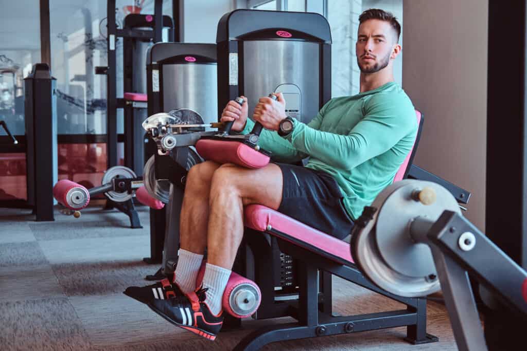 man working out legs on gym machine