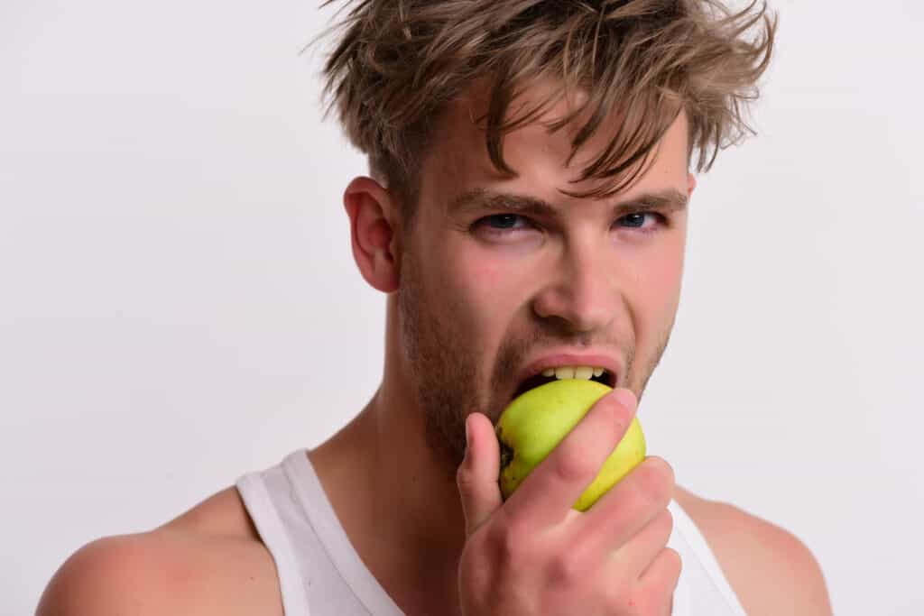 man biting apple