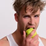 man biting apple