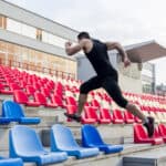 man running up stadium steps