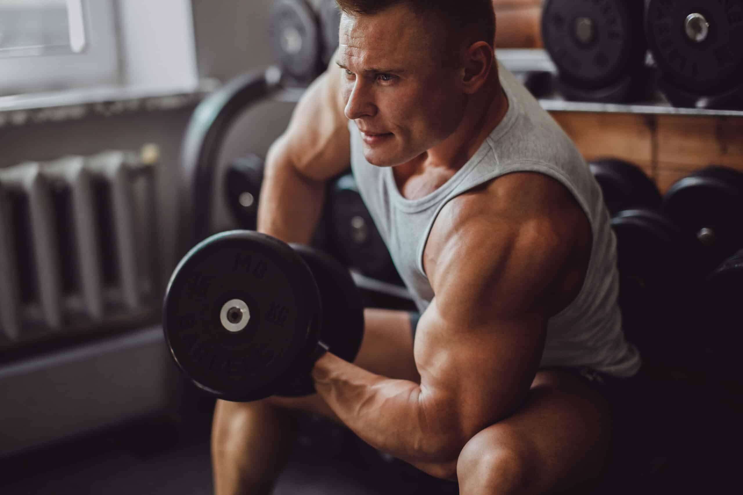 muscular man doing bicep curls at home