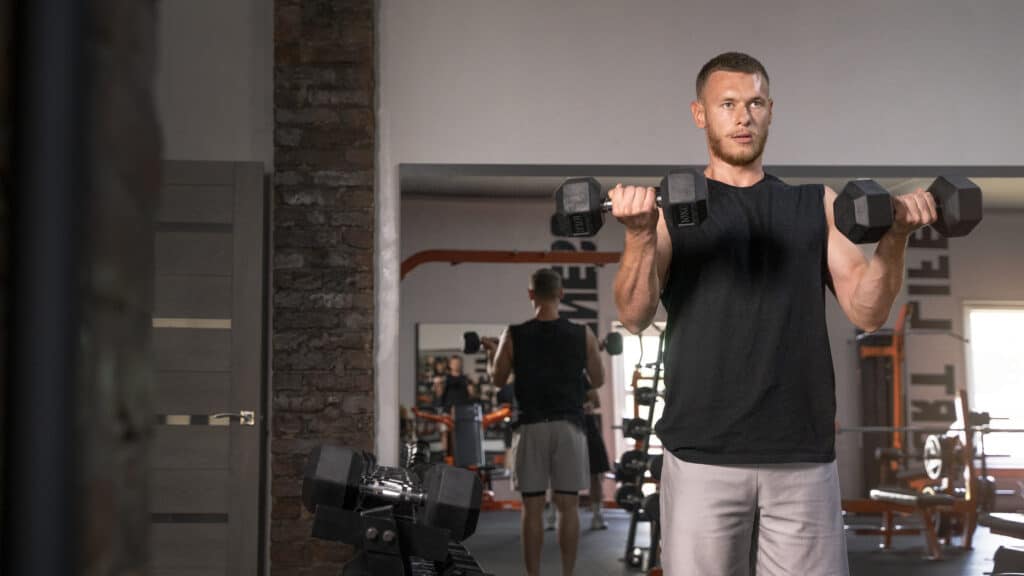 man doing dumbbell based exercises