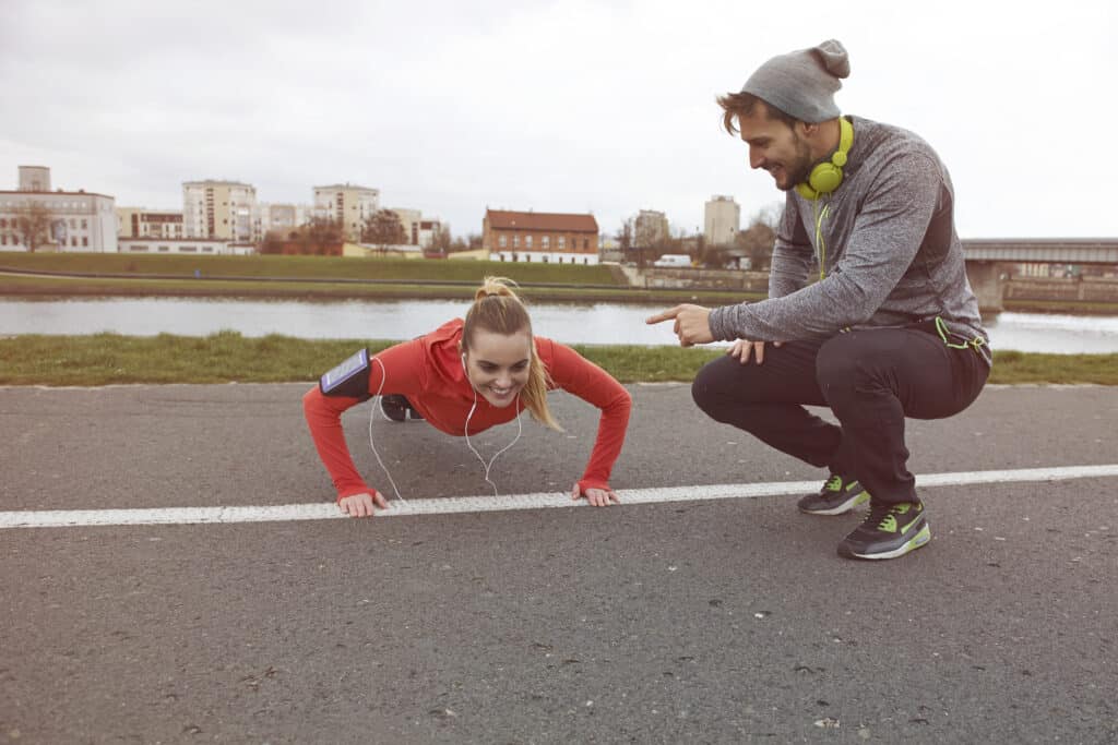 Couple exercising together doing pushups
